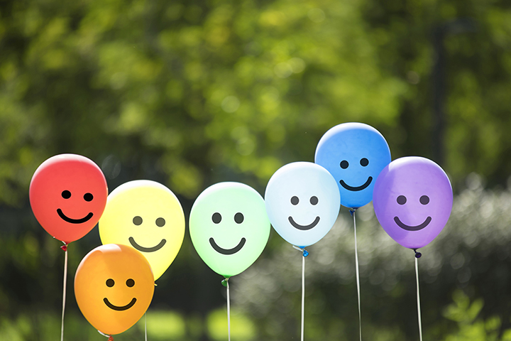 group of balloons with smiles on the front, multi-colored