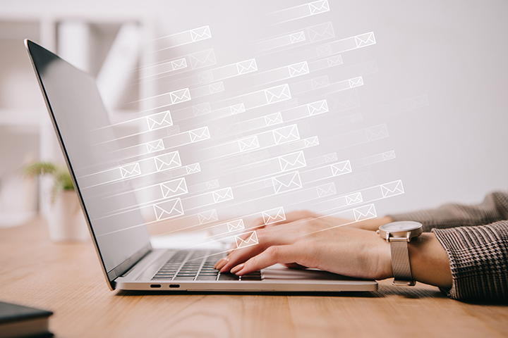 woman typing on laptop sending mails