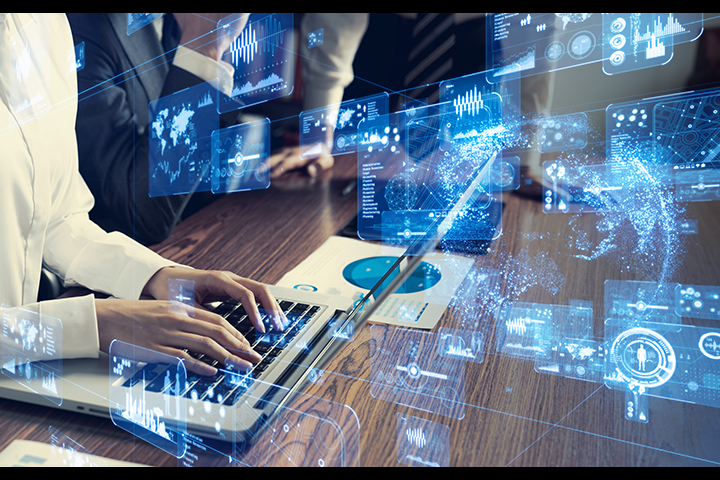 hands working on a computer with graphics of numbers and code in front