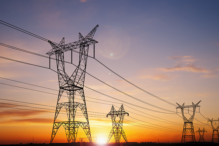 Electricity power pylons over sunset