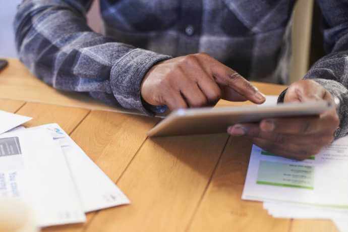 man tapping on tablet