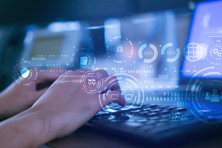 man typing with various virtual data displayed