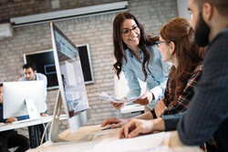 people at computer collaborating on communications workflow 