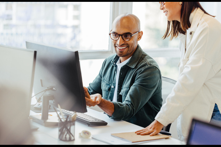 colleagues viewing a monitor