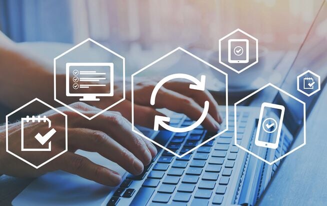 Person working on laptop initiating an automatic software update