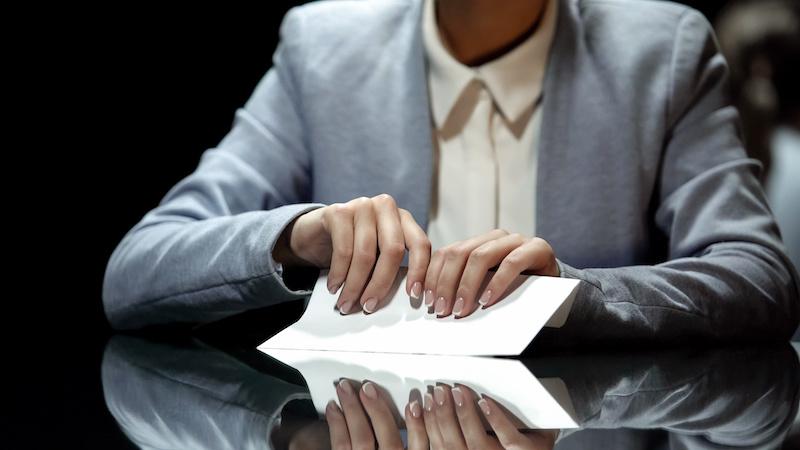 a business woman holding an envelope
