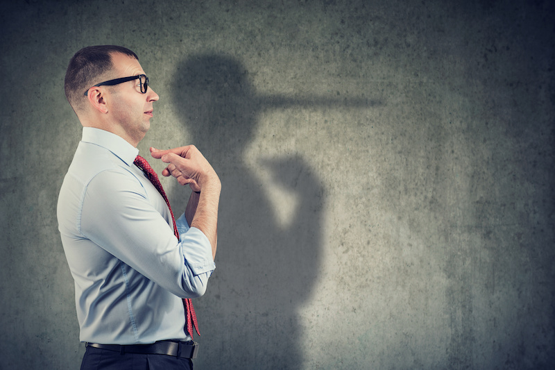 a businessman pointing towards himself