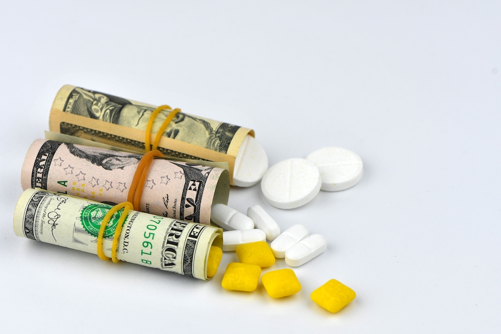 Pills from a pharmacy and money rolled up