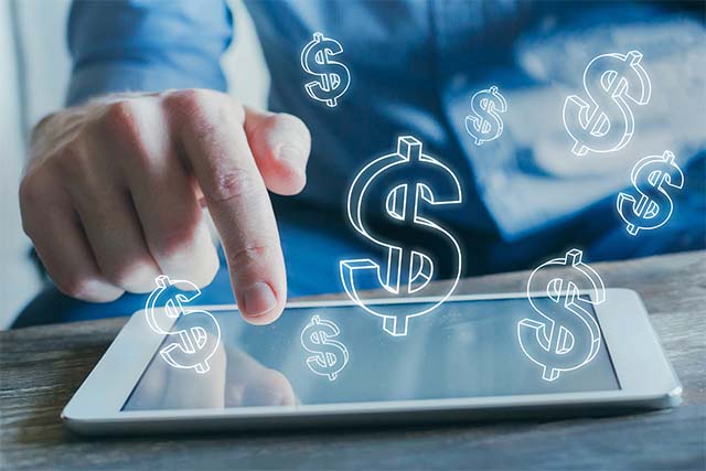 Dollar signs emitting from a tablet screen
