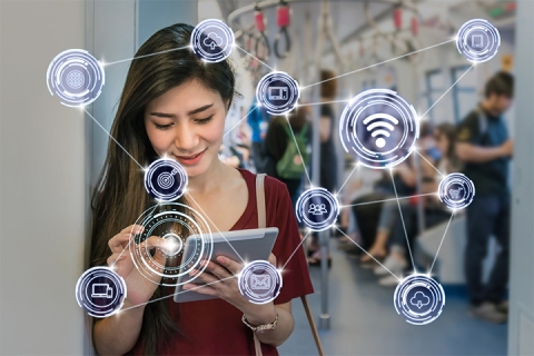 Woman working on her tablet with a network of digital icons
