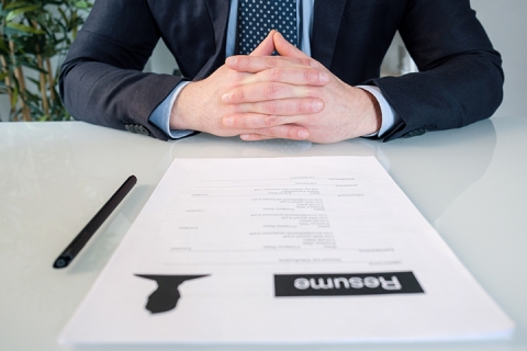 a business executive sitting in an office with papers ready to be signed