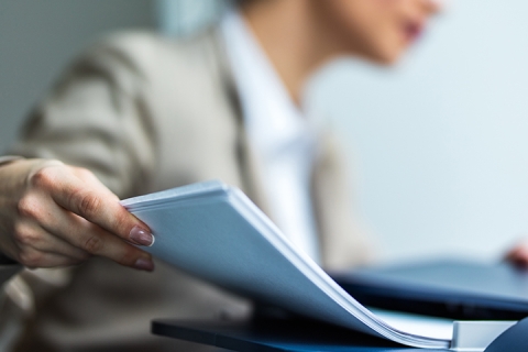 person handling paperwork in an office