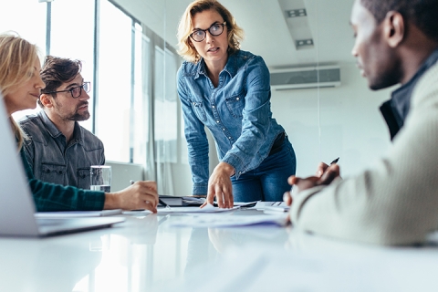 Businesswoman standing and leading business presentation