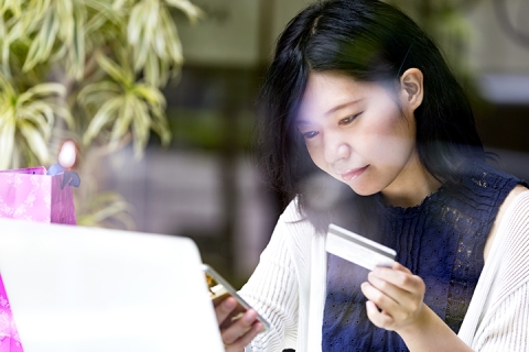 girl at cafe, while waiting using her smartphone 