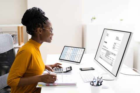 woman working on computer at her desk in an office
