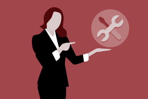 Femme conçue graphique pointant vers un ensemble d’outils avec un fond rouge