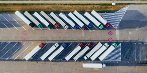 Aerial shot of tractor trailers lined up in diagonal parking spaces