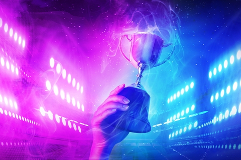 hand holding trophy with smoke effect and neon background
