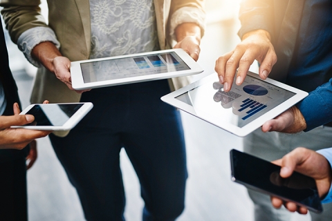 Cropped shot of unrecognizable businesspeople using their wireless devices in the office