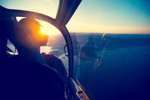 Pilot communicating to passengers over PA System, view of the horizon