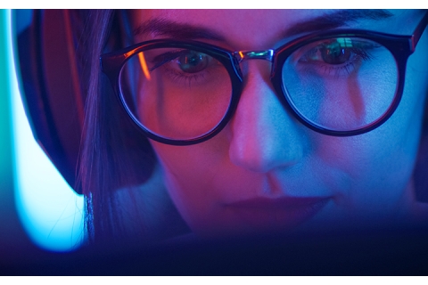 girl with glasses working at a computer 
