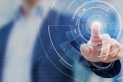 man with finger touching a complex circular diagram on virtual screen