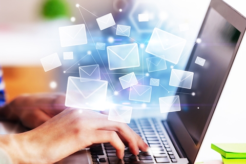hands working at a laptop using email and other digital communication networks