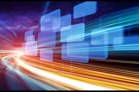 Blurred beams of light whizzing past digital screens