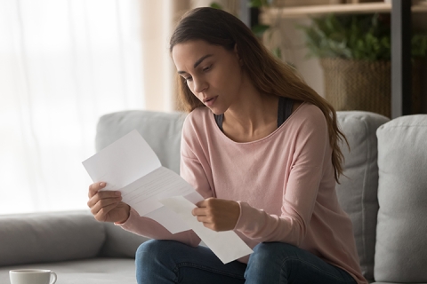 woman engaged in reading a paper 