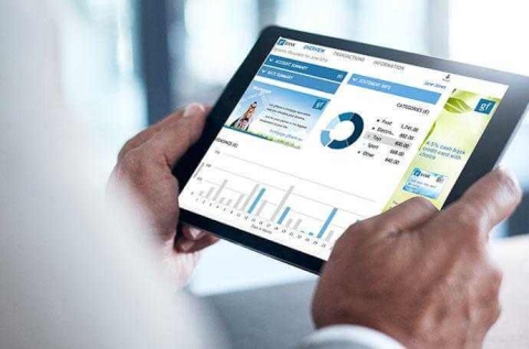 man holding a tablet showing graphs and charts