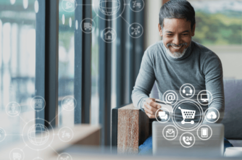 Customer smiling at invoicing portal on his laptop