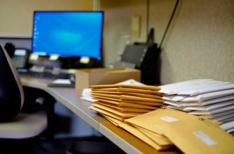 mail piled on an office desk