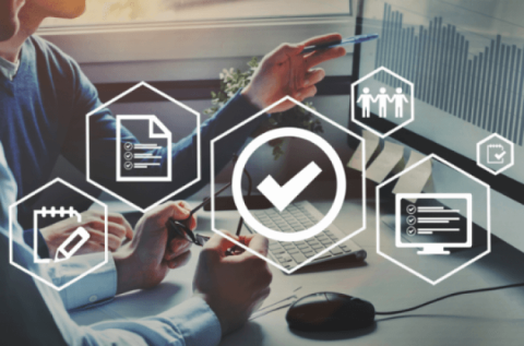 Secure symbol and employees pointing at a computer screen