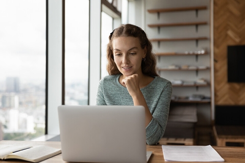 woman watching virtual webinar on laptop
