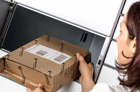 woman collecting a parcel from a parcel locker
