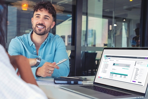 smiling man consulting woman working on laptop
