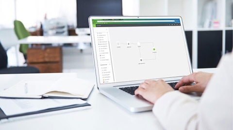 businessman designing a communications workflow on laptop