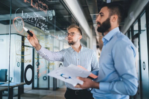 2 men looking at wall