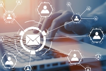 Digital mail icons in front of computer