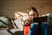 Woman and emotional support dog looking at tablet, communication