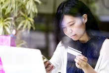girl at cafe, while waiting using her smartphone 