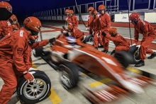 blurred race car leaving the pit after tire change and service