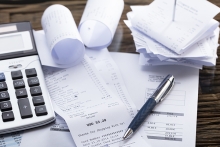 elevated view of calculator and pen on receipt in office