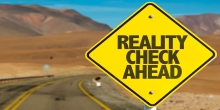 reality check ahead written on a road sign 