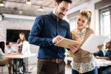 young architects discussing in office with tablet