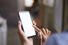 Fingertips touching and tapping on a phone