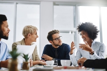 a group of businesspeople sitting together in a meeting