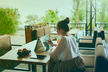 Person working on tablet on a patio