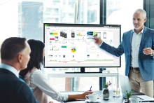 man presenting customer journey map to team