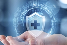 hand holding medical shield with cityscape globe 